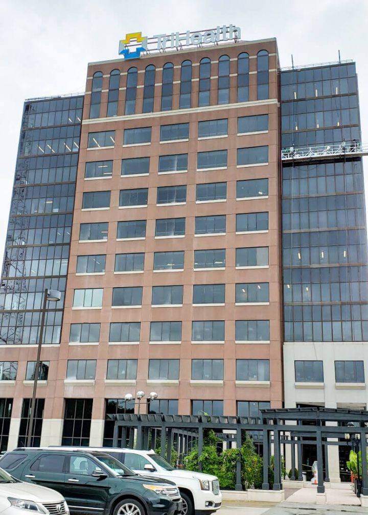 Presto technicians on swing stage performing surface restoration and waterproofing services on Cincinnati office building