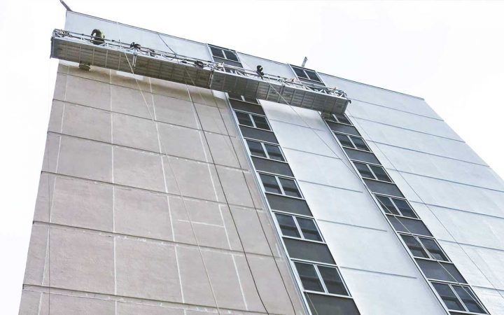 Presto applying an elastomeric coating to the EIFS of a commerical building