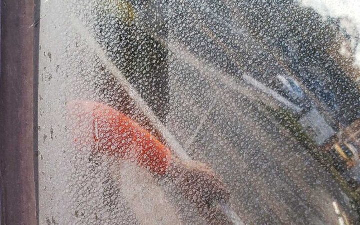 Mineral-Deposit-Removal-Services Window covered in hardwater stains which are a type of mineral deposit