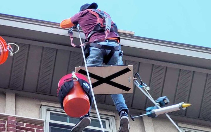 Professional sealing and caulking a commercial building