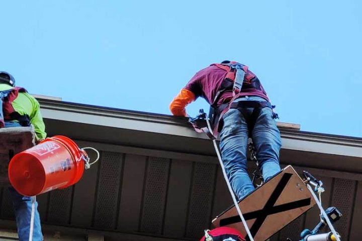 Using a char to access hard to reach areas of a condo building during waterproofing services