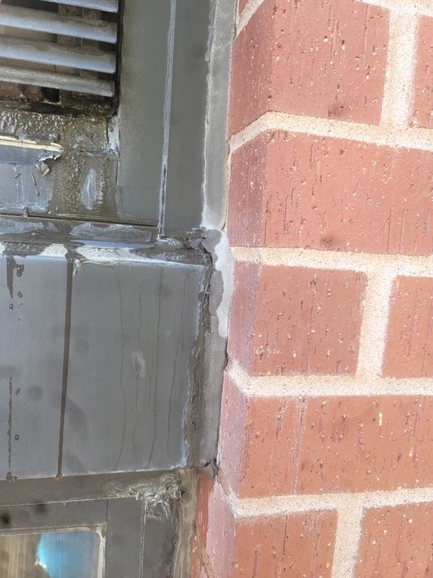 Window perimeter caulking failure at building facade joints in Kansas City, MO