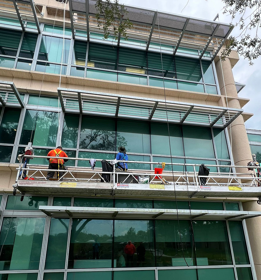 Commercial caulking contractor completing wet glazing repairs at a commercial office building in Tampa, FL