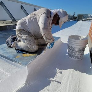 Coating a single-ply roof system on a San Antonio TX commercial building